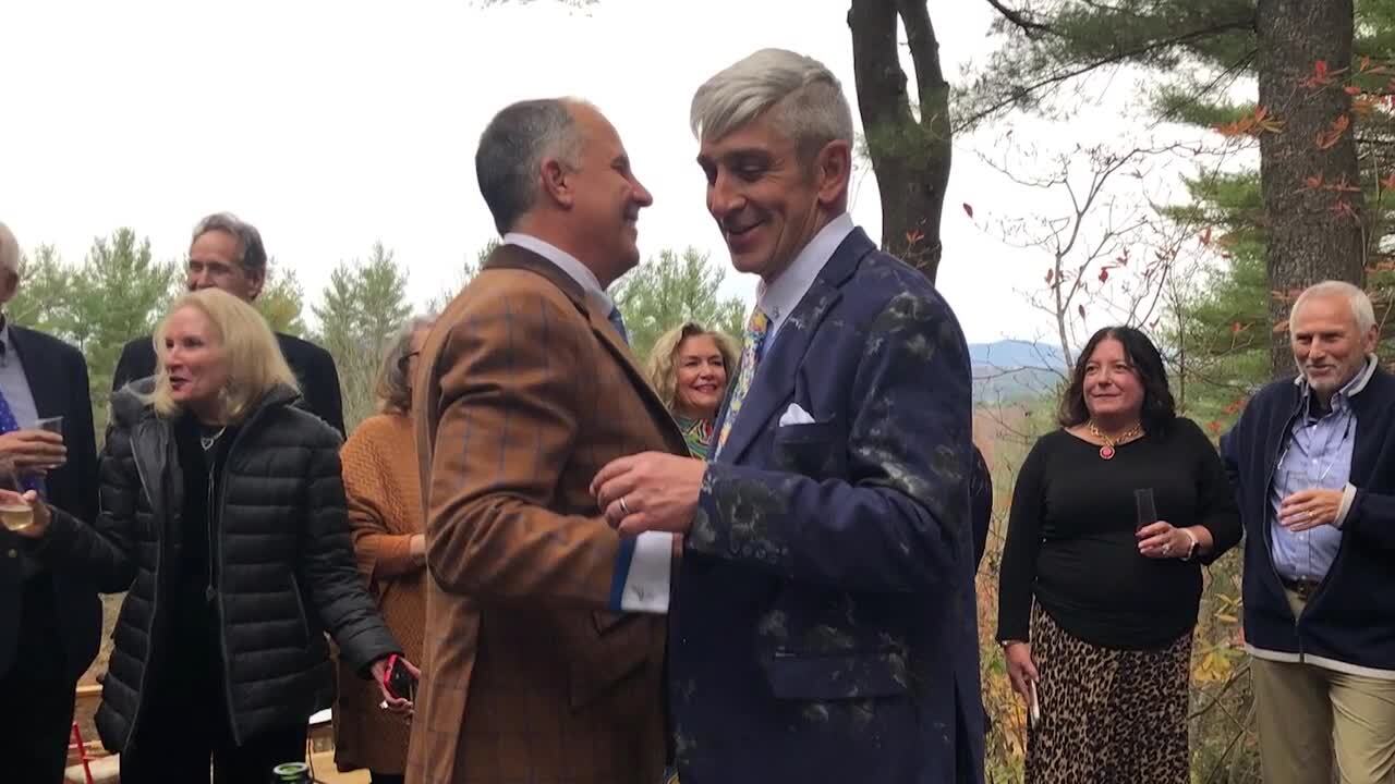 Two middle aged gentlemen shaking hands.