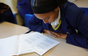 A student reads a handout in the classroom.