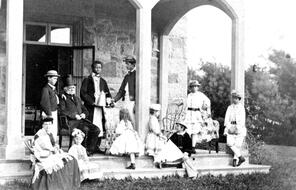 Eliza "Didy" Ridgely White, her extended family, and their servants are seen on the porch at the Bruen Villa on Bellevue Avenue in Newport, Rhode Island.