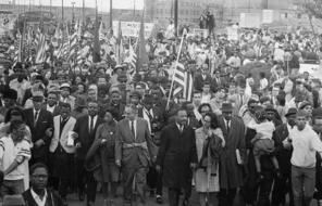Dr. Martin Luther King leads thousands of civil rights demonstrators out on the last leg of their Selma to Montgomery 50-mile hike.