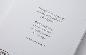The back of a white book with a quote from Brianna Wiest which reads "I thought becoming myself was improving each part piece by piece. But it was finding a hidden wholeness seeing the fractures at the design."