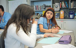 A student and teacher are in discussion.