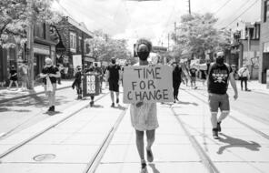 Black and white image of time for change protestor.