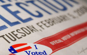 English language newspaper from election day with an "I voted" sticker.