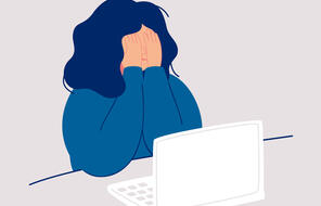 Graphic image: woman sits at the computer and crying covering her face with her hands