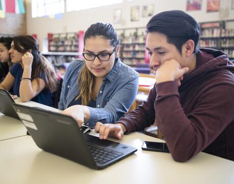 Students in library working on computers